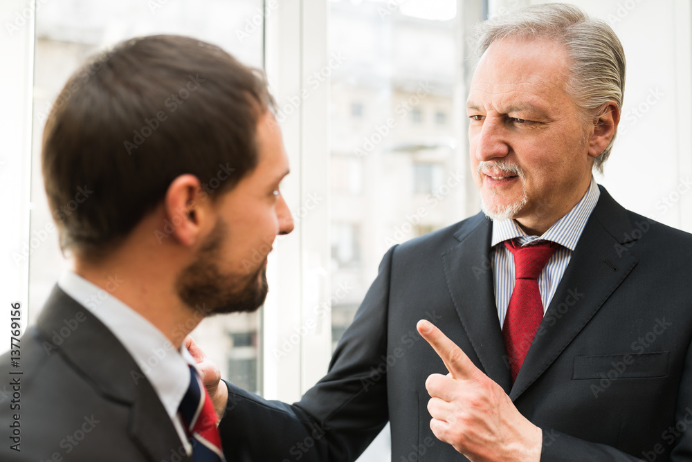 Fototapeta premium Senior businessman talking to a younger colleague