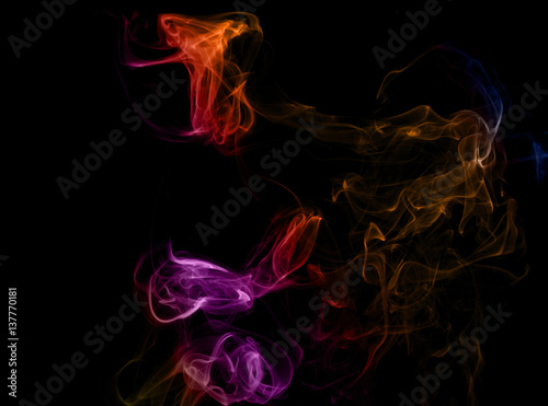 Colored smoke on a black background. Abstract flower