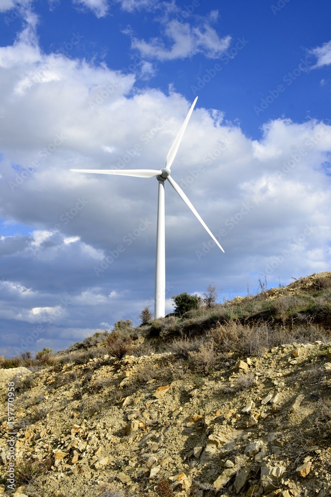Landscape with cloudy sky and details of a windmill Landscape with cloudy sky and details of a windmill