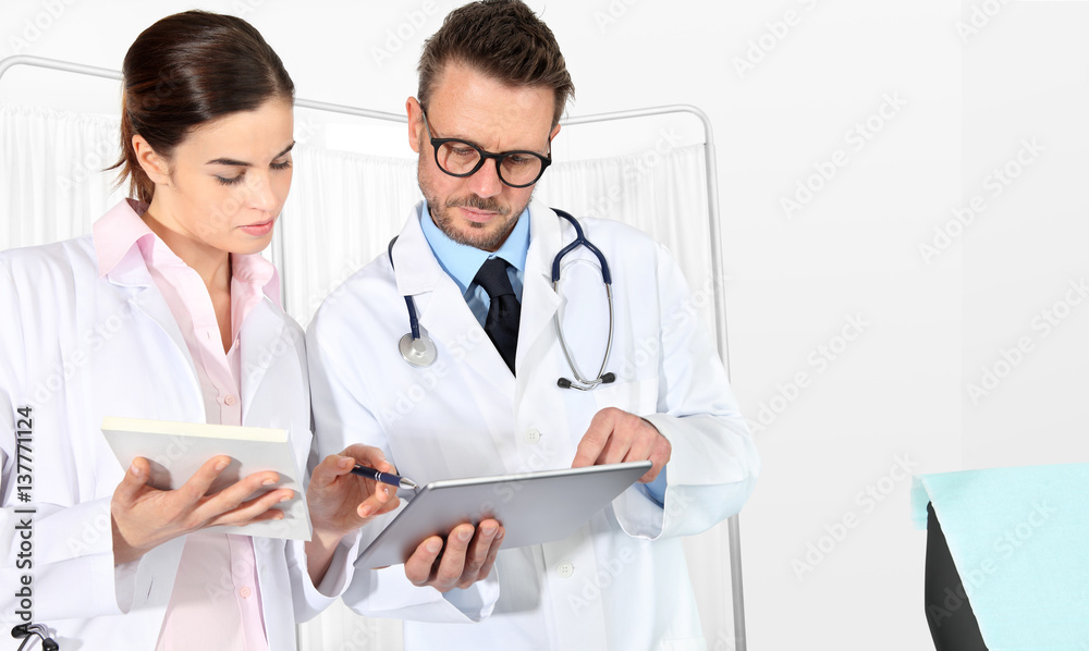 Doctors using a tablet, concept of medical consulting Doctors using a tablet, concept of medical consulting