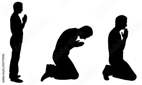 Silhouettes of men praying isolated on white