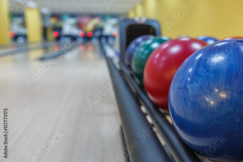 Bowling balls return machine, alley background © Prostock-studio