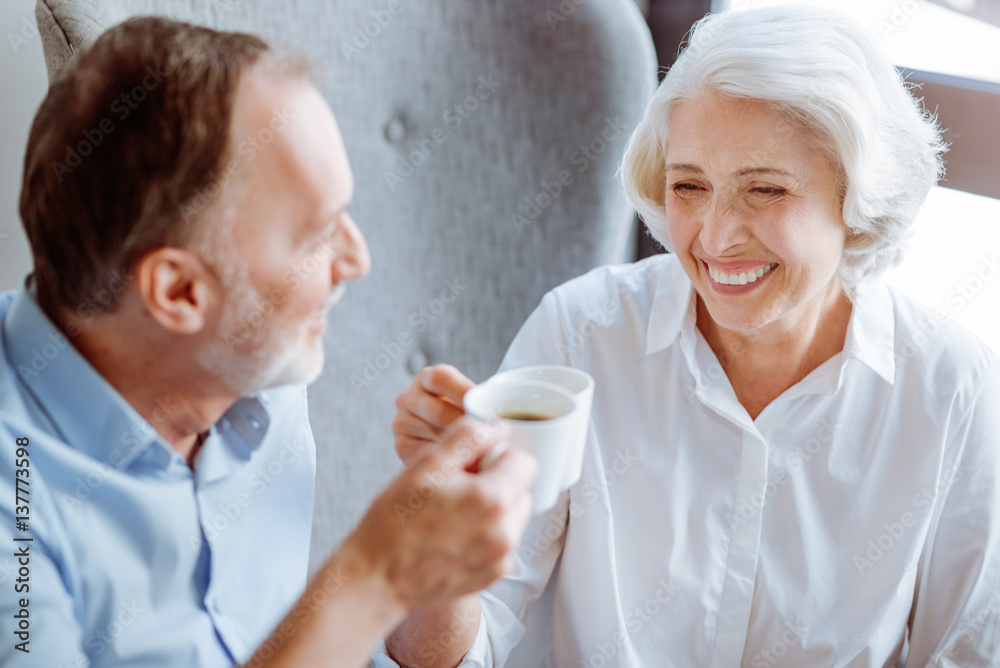 Positive aged couple resting in the cafe Positive aged couple resting in the cafe