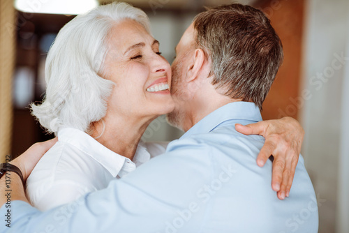 Positive aged couple embracing