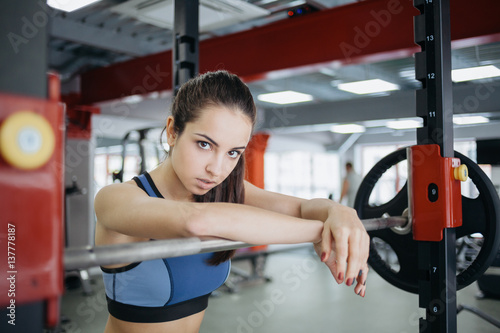 Young woman at the gym using fitness equipment.