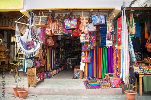 Shop with traditional colorful handmade bag and rug in Panajachel, Guatemala.
