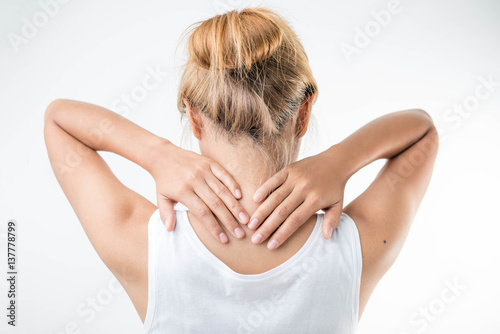 Young woman with pain in the back of her neck.,health care concept.