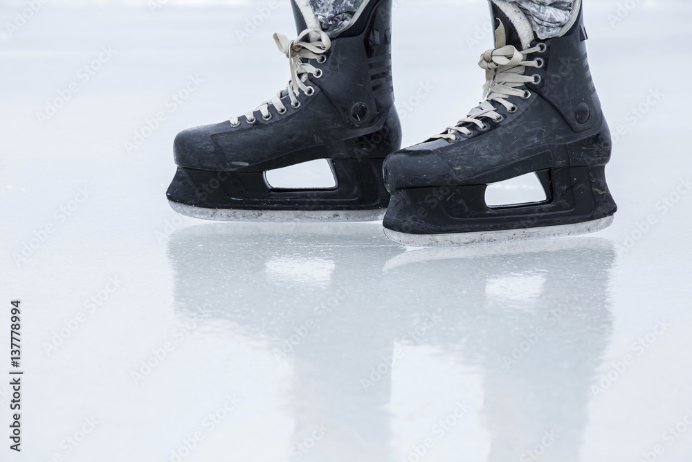 Man skating with black skates on the ice area at the seashore in winter day. Weekends activities outdoor in cold weather. Man skating with black skates on the ice area at the seashore in winter day. Weekends activities outdoor in cold weather.