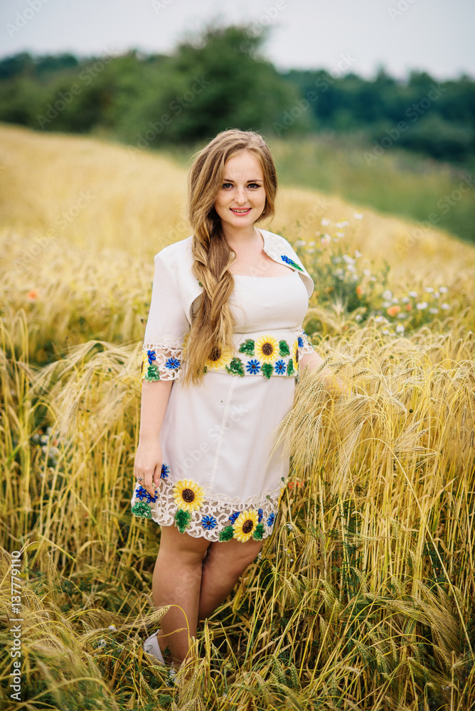 Young girl at ukrainian national dress posed at wreath field. Young girl at ukrainian national dress posed at wreath field.