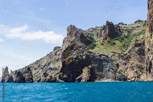 Rocky coastline of south Crimea. View from the sea: golden gates of Karadag