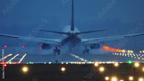 Boeing 737-800 Commercial Jet Plane Landing at Night.