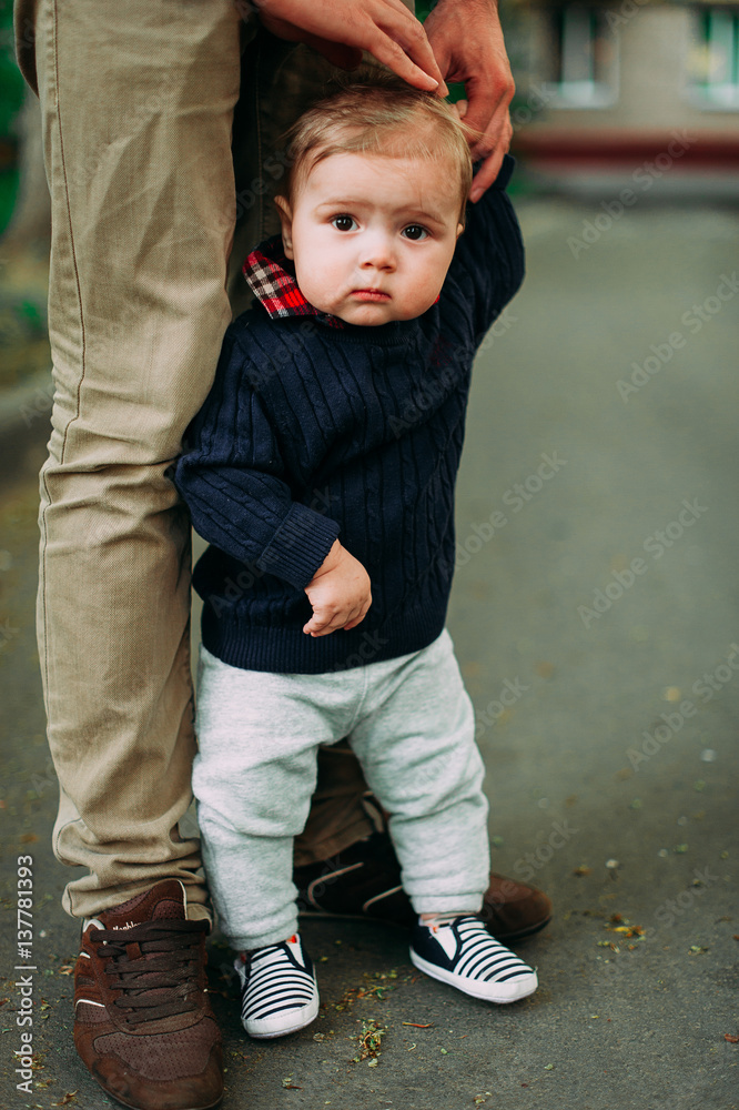 beautiful baby boy staying holding father's hand, 9months beautiful baby boy staying holding father's hand, 9months