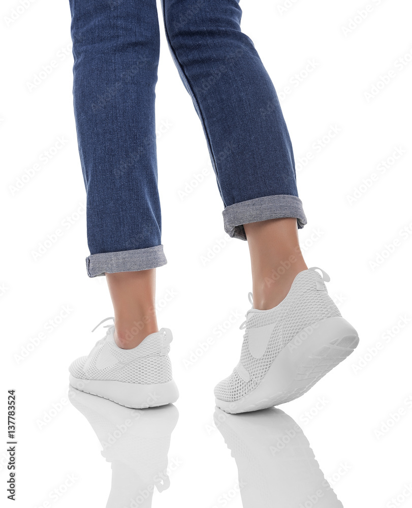 Female feet in sneakers. Do step.