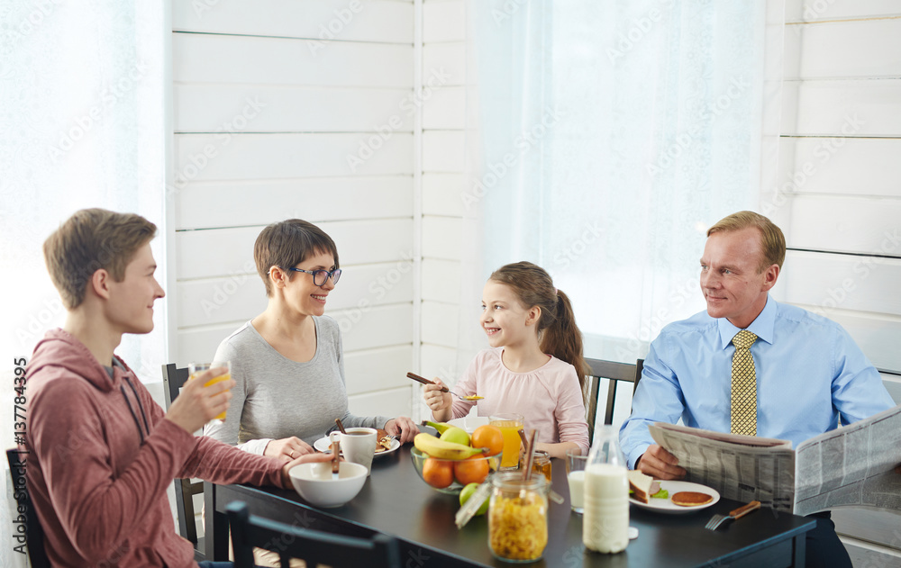 Healthy family of four having eco food for breakfast