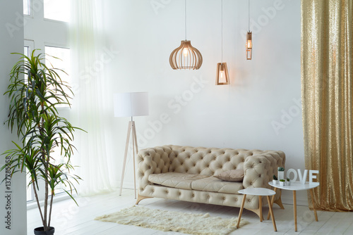 Interior living room with a sofa, table, floor lamp and panoramic window