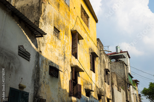 Yellow wall of aged classic style house in Hanoi, Vietnam