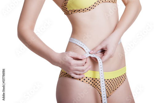 Woman measuring her slim body isolated 