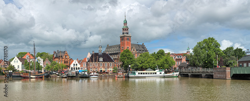 Leer, Germany. Panoramic view from Leda river on City Hall in Dutch Renaissance style, Old Weigh House in Dutch classical Baroque style, Tourist Harbor and Bridge of Erich vom Bruch. photo