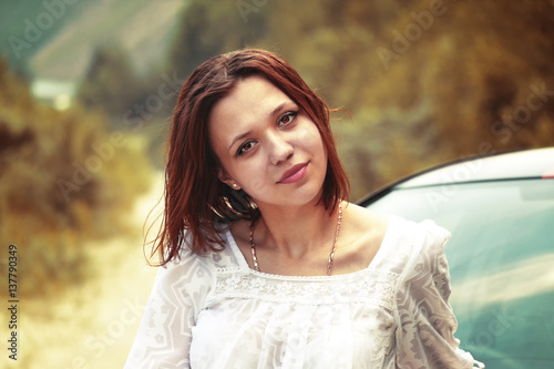 Beautiful portrait of a young girl on the natural background