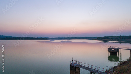 arial View of country Beautiful tranquil lake and dam against mountain background at twilight sky - drone camera.