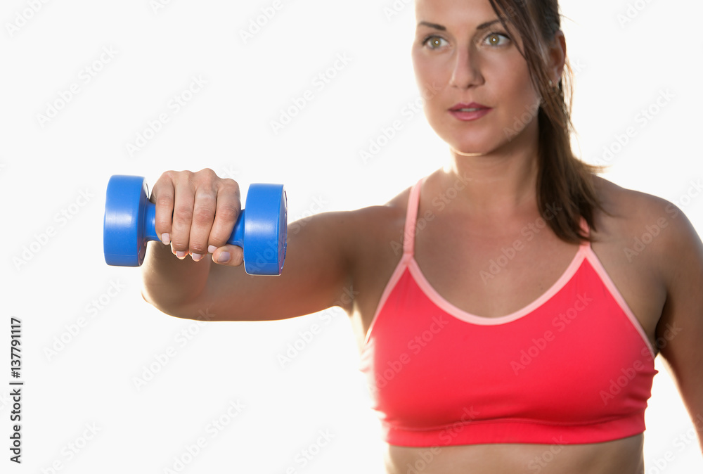 Athletic woman works out with dumbbells isolated over white background Athletic woman works out with dumbbells isolated over white background