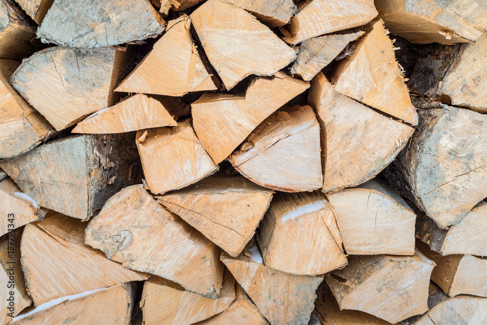 Background of dry chopped firewood logs in a pile Background of dry chopped firewood logs in a pile