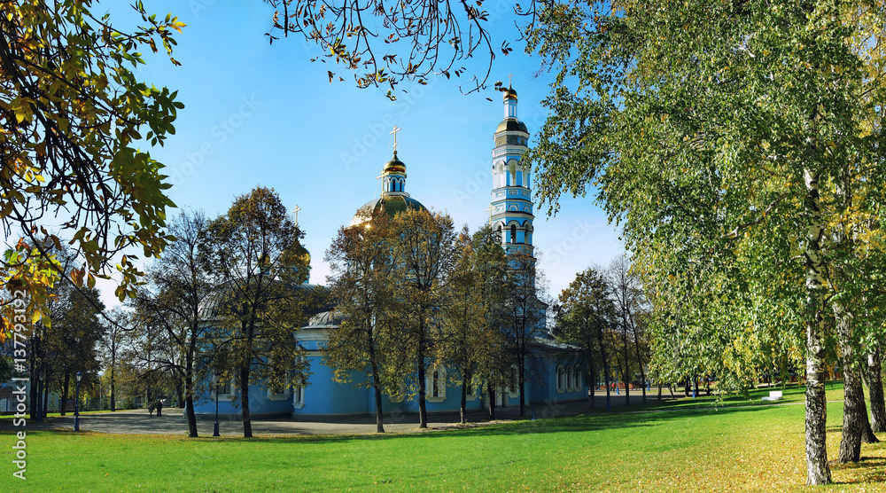 Naklejka premium Blue Orthodox Church with a green lawn in summer
