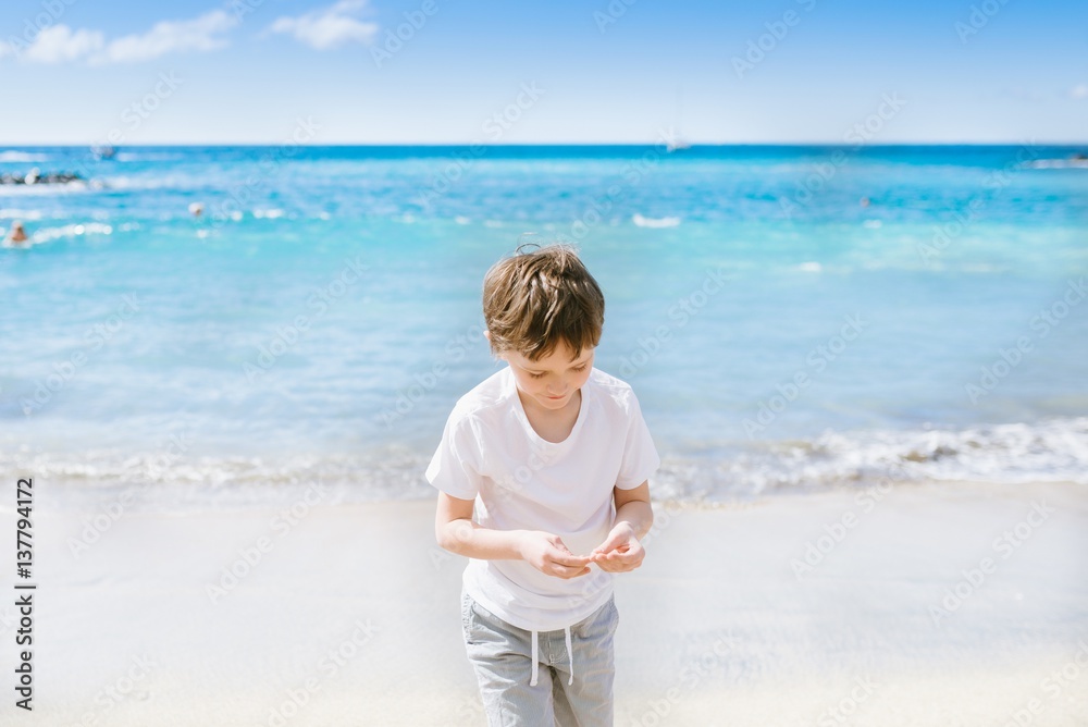 Happy 7 years boy child walking on the beach. Happy 7 years boy child walking on the beach.