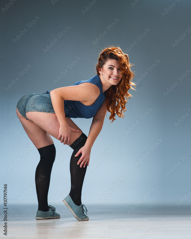 twerk redhead woman in jeans shorts Stock Photo | Adobe Stock