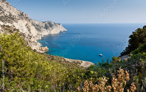 View of Atlantis bay at Ibiza. Yacht near ibiza coast. Luxury rest at Balearic Islands. Beautiful place for diving and swimming. Holidays and fishing in the Mediterranean.