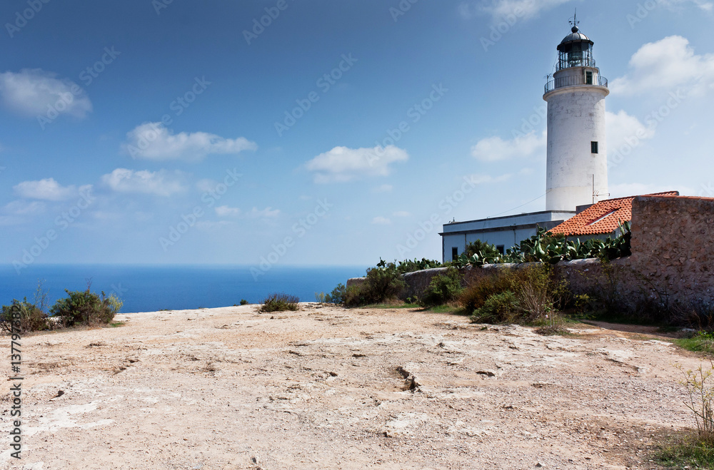 Beacon at Formentera cliff. Skyline of the Mediterranean Sea. Popular touristic place.