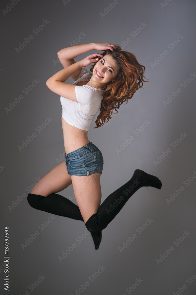 twerk redhead woman in jeans shorts Stock Photo | Adobe Stock