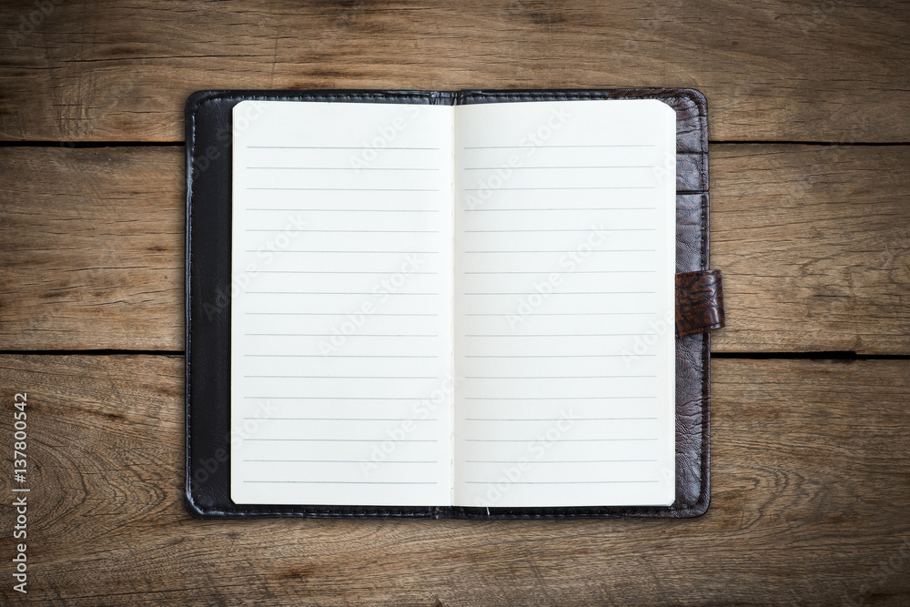 Open blank notebook on wood background. Open blank notebook on wood background.