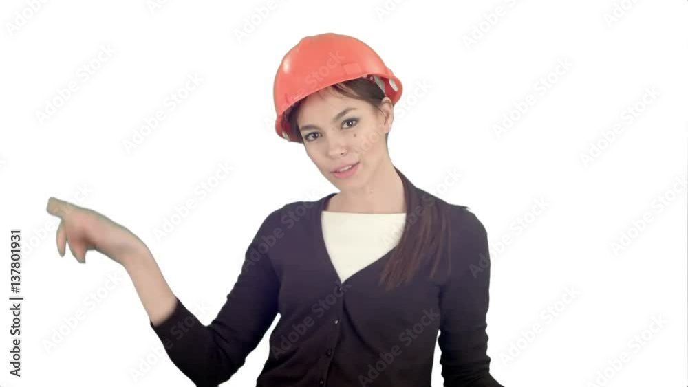 Female engineer in hardhat holding papers and doing silly dance on white background Female engineer in hardhat holding papers and doing silly dance on white background