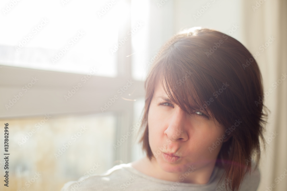 Angry girl frowns face and dissatisfied looks ahead Angry girl frowns face and dissatisfied looks ahead