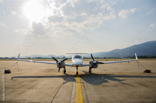 Small Airplane or Aeroplane Parked at Airport.Small Airplane Famous to use Private Airplane.Sun Light and Mountain View.