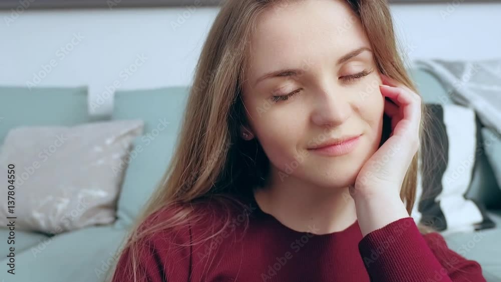 Close up of beautiful smiling young woman with long hair at home Close up of beautiful smiling young woman with long hair at home