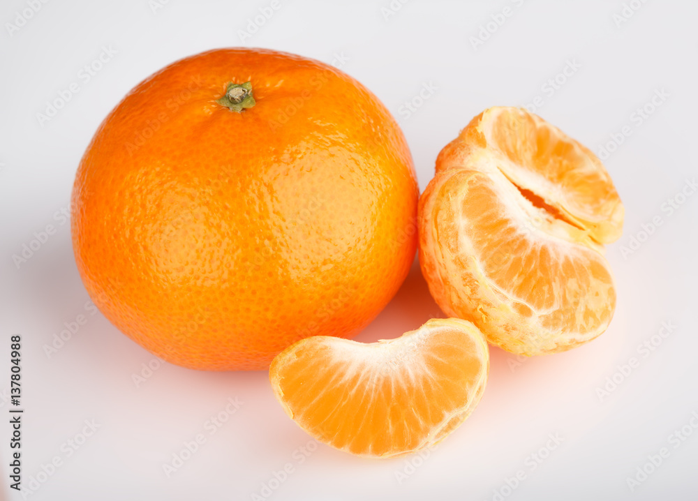 Ripe mandarin close-up on a white background. Tangerine orange. Colorful Food and drink still life concept. Fresh fruits and vegetables on color background. Clementine. Citrus. Fresh fruits. Diet. Ripe mandarin close-up on a white background. Tangerine orange. Colorful Food and drink still life concept. Fresh fruits and vegetables on color background. Clementine. Citrus. Fresh fruits. Diet.