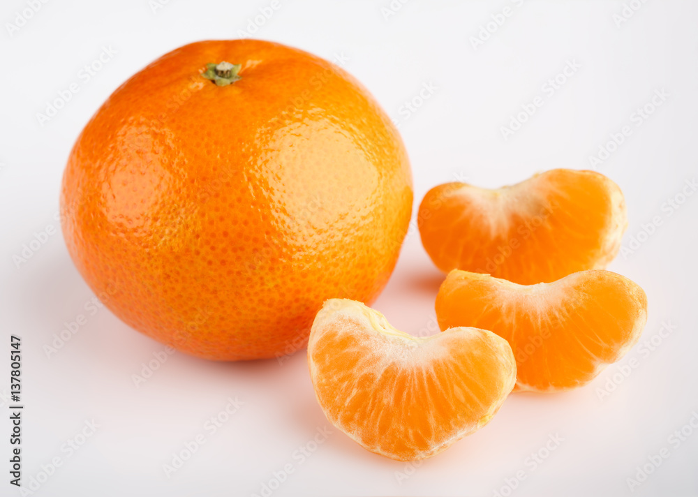 Ripe mandarin close-up on a white background. Tangerine orange. Colorful Food and drink still life concept. Fresh fruits and vegetables on color background. Clementine. Citrus. Fresh fruits. Diet. Ripe mandarin close-up on a white background. Tangerine orange. Colorful Food and drink still life concept. Fresh fruits and vegetables on color background. Clementine. Citrus. Fresh fruits. Diet.