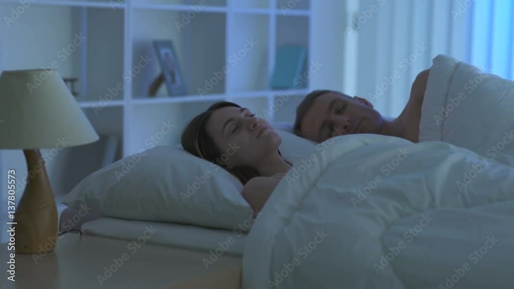 The couple sleeping on the bed. Camera around motion