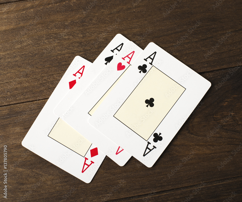 Four aces on wooden table. Poker.