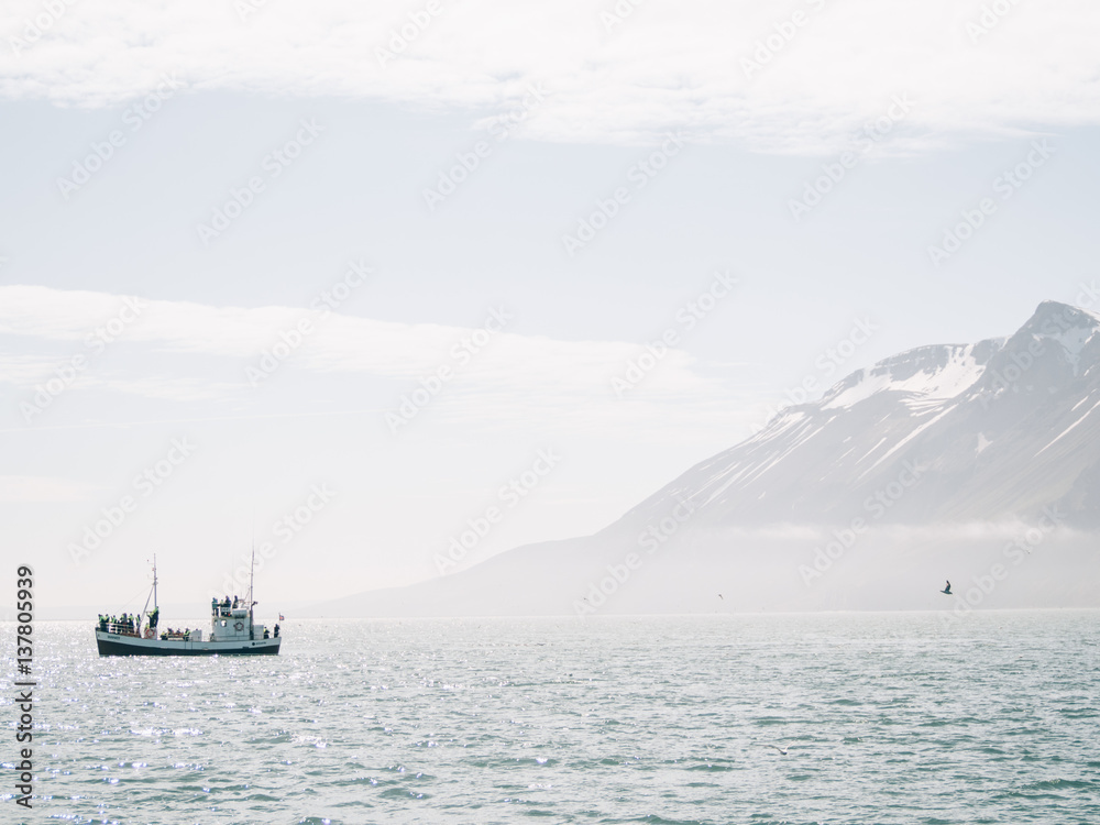 A boat floating near mountains A boat floating near mountains
