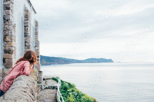 A person looking at the coastline photo