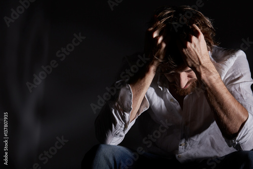 Man suffering emotional pain photo