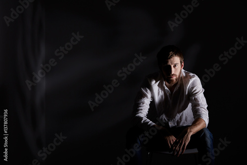 Desperate man sitting alone