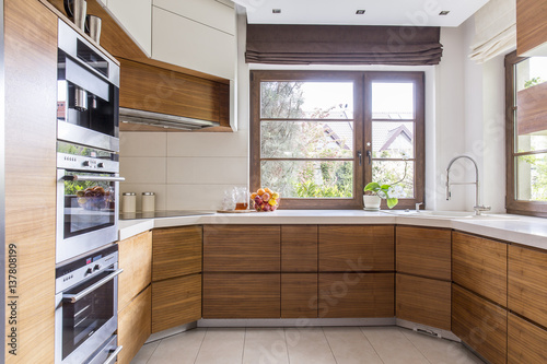 Obraz na plátně Wooden cupboards in new kitchen