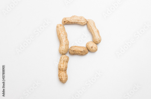 Closeup of peanut  in P english alphabet isolated on white background