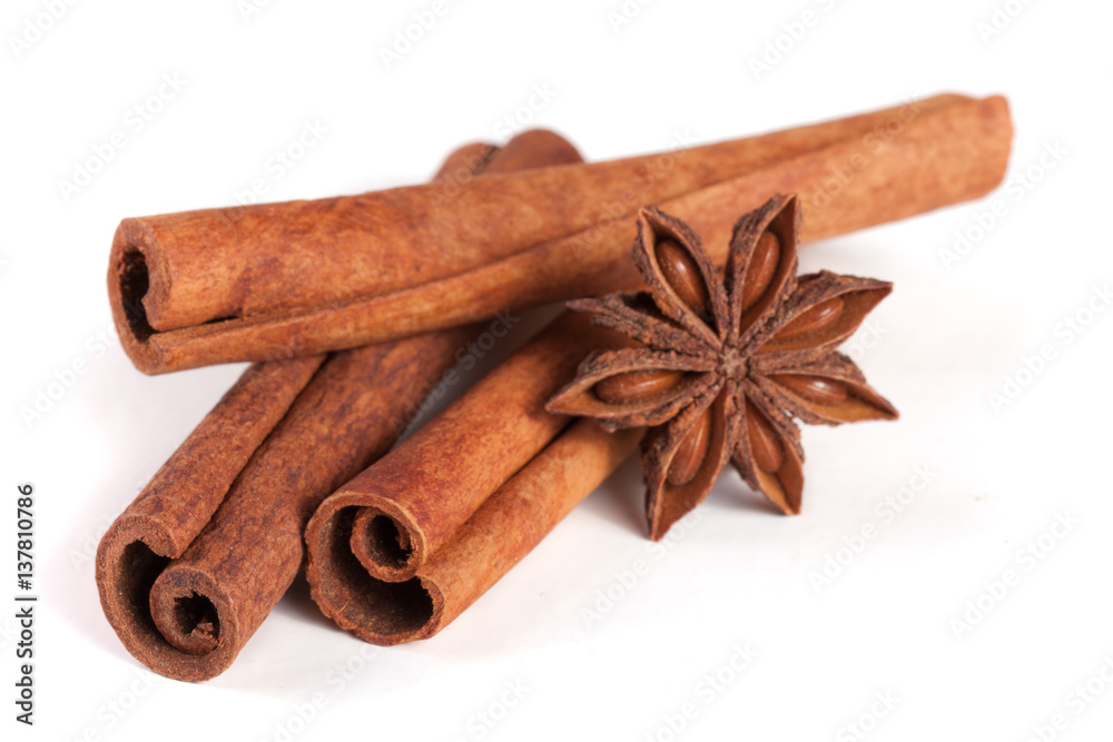 three cinnamon sticks with star anise isolated on white background three cinnamon sticks with star anise isolated on white background