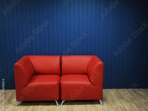 Red leather sofa on a background of blue walls. Texture for the design © sorocka