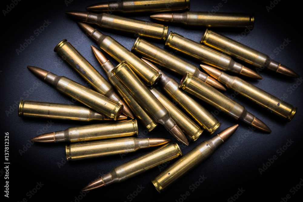 Rifle cartridges 5.56 mm on black background Rifle cartridges 5.56 mm on black background
